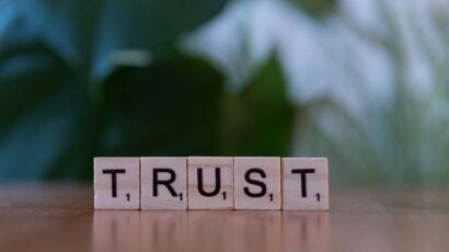 A wooden block spelling trust on a table